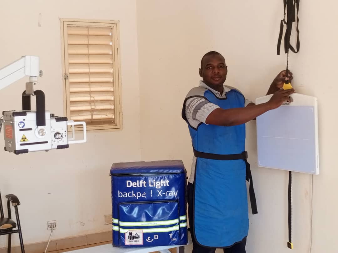 A radiographer stands next to the Delft Light in Burkina Faso