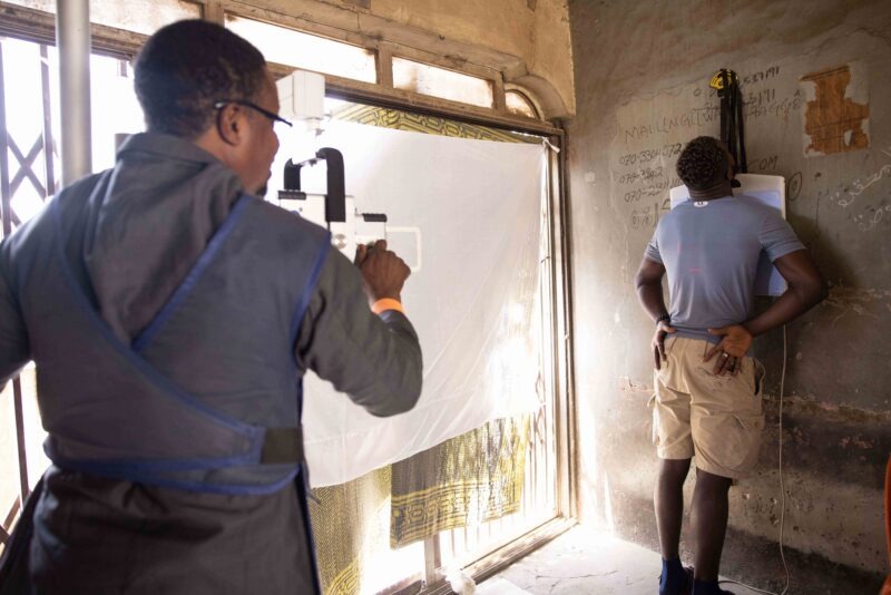 The radiographer is holding the Delft Light in Nigeria