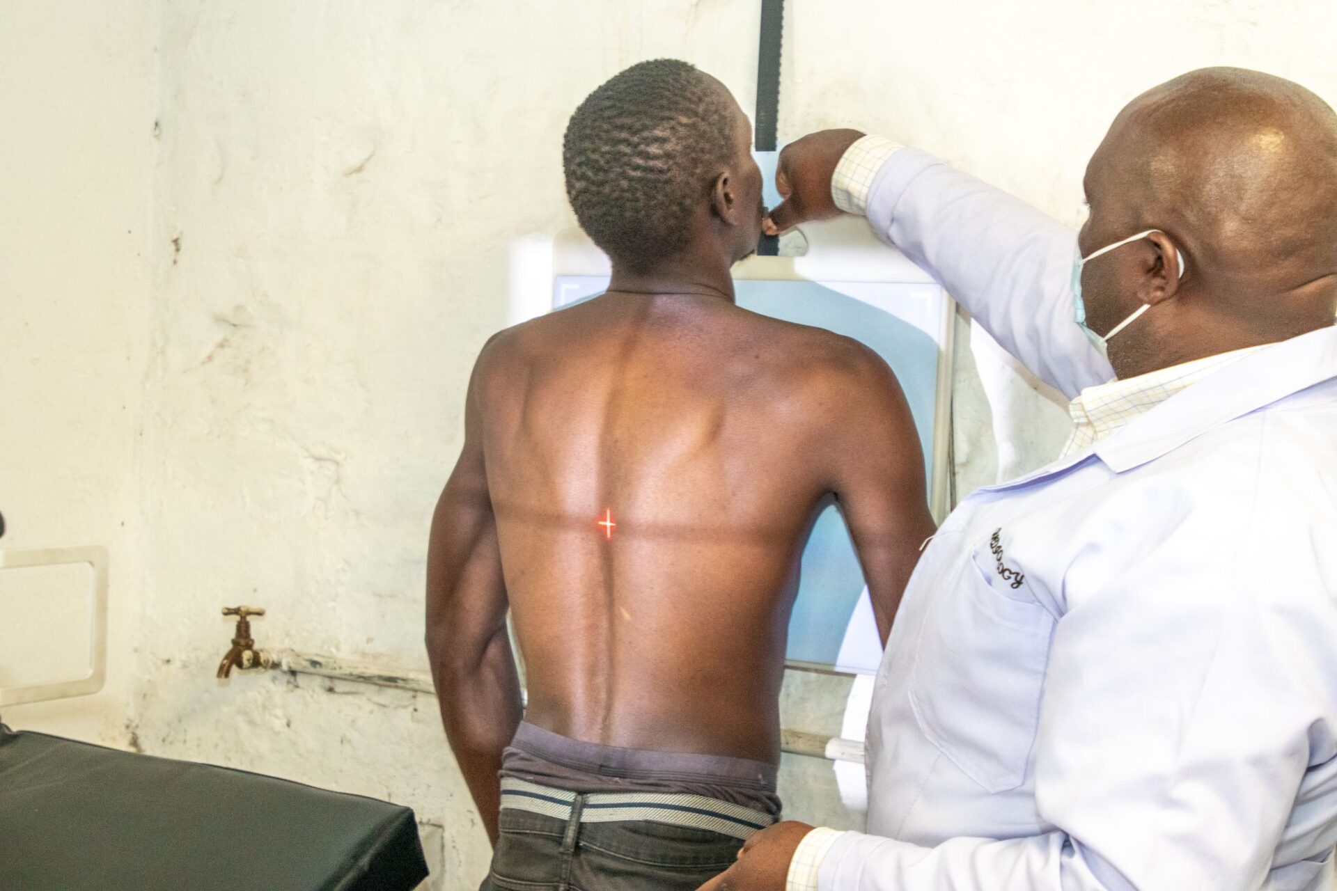 A patient is being guided to do a chest X-ray in Kenya