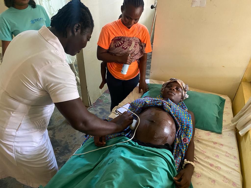 The midwife is using BabyChecker to scan the pregnant women in Ghana