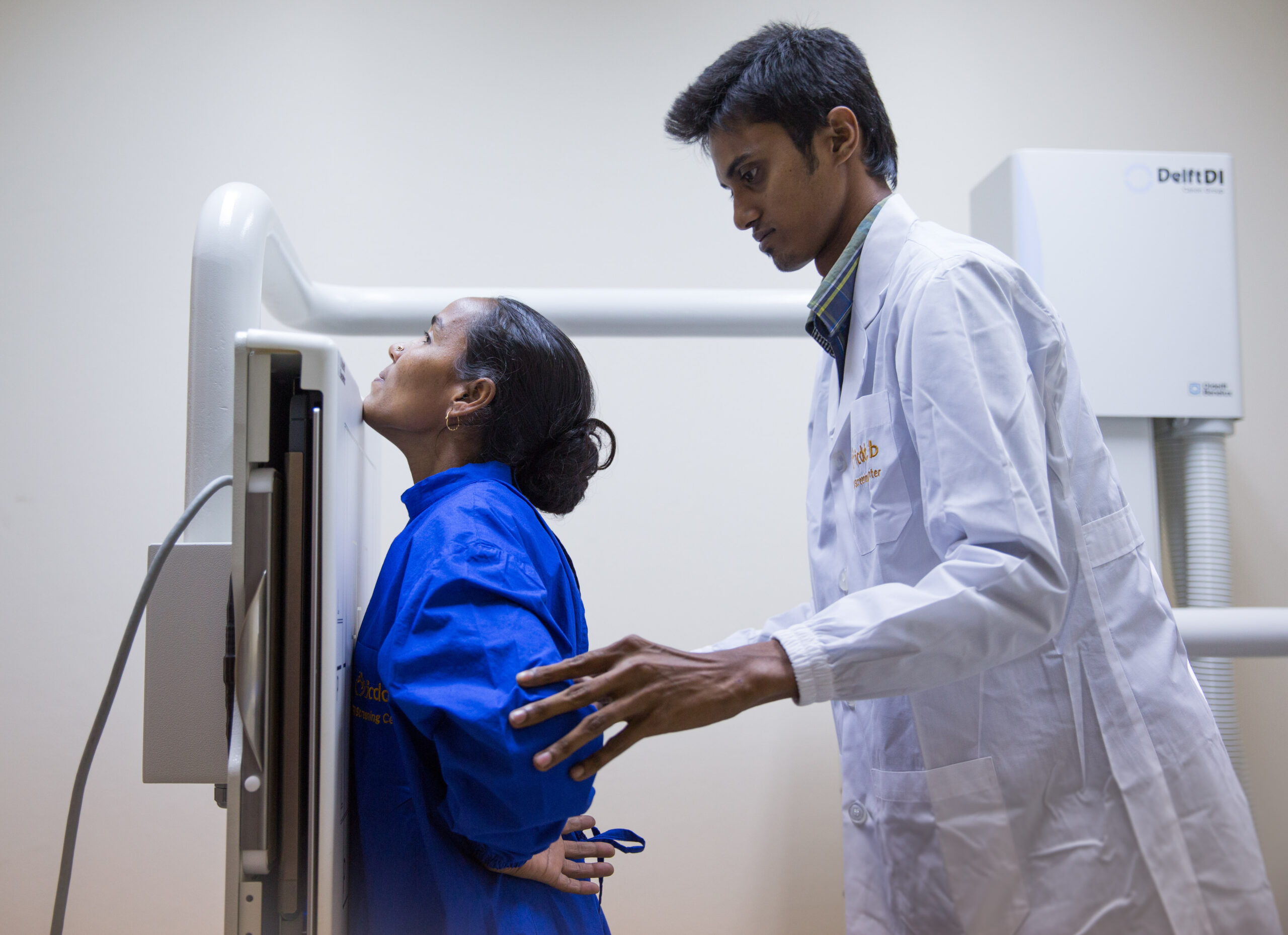 A radiographer is guiding the patient in Bangladesh to scan with EasyDR