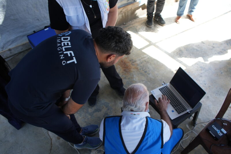 Delft colleague and the radiographer are looking at the CAD4TB screen to examine the result in Lebanon
