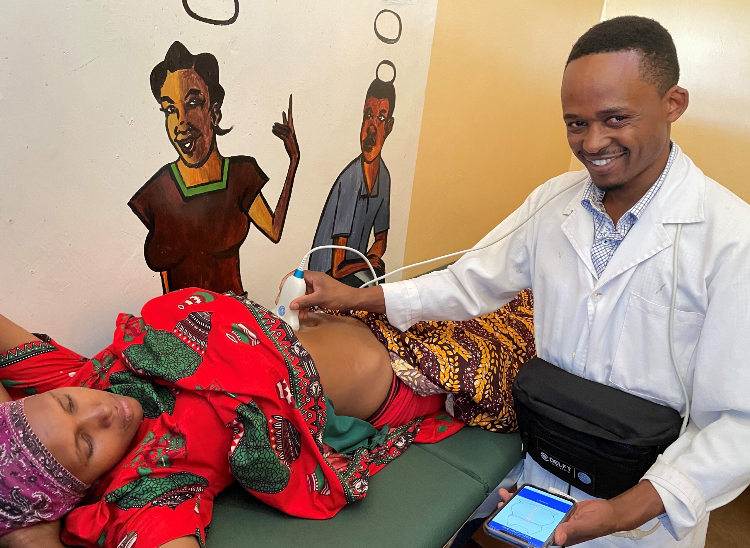 Erick - the nurse uses BabyChecker to scan a pregnant women in Tanzania