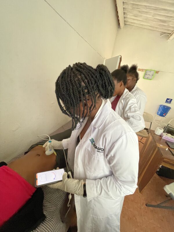 a midwife from Dawa Health, Zambia is using BabyChecker to scan a pregnant women