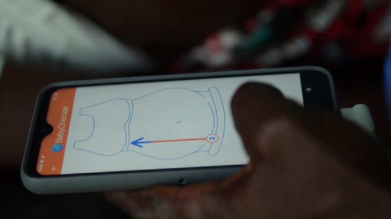 A midwife is showing the BabyChecker app