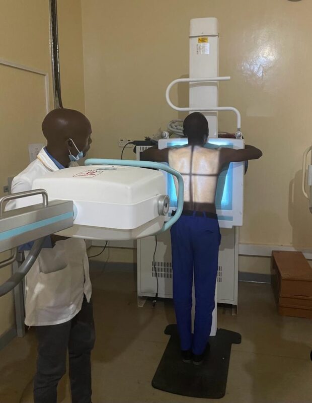 The radiographer is screening a patient with Delft MAC in Malawi