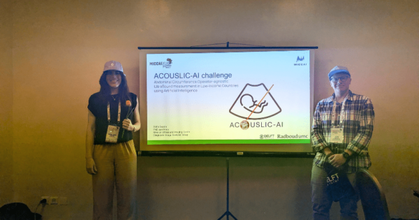 Sofia Sappia and Julio Lopez took a picture with each other with the background of ACOUSLIS challenge