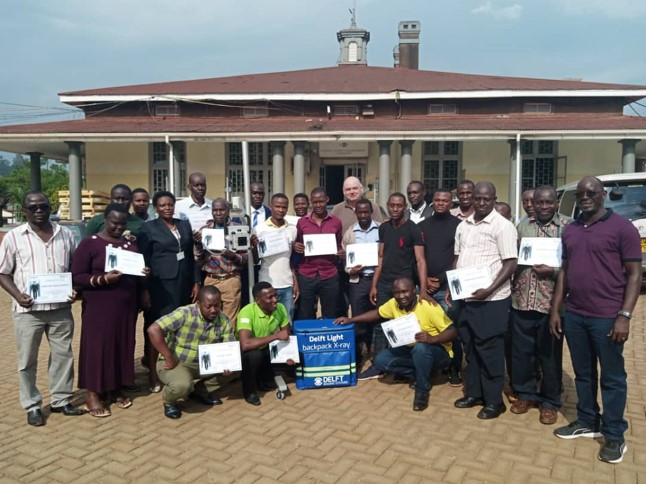 Group photos of stakeholders in Uganda receiving the Delft Light and CAD4TB