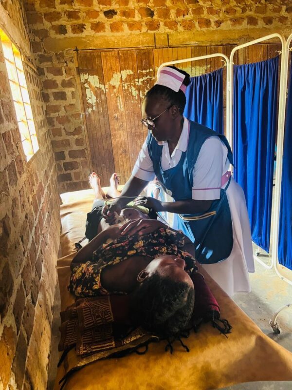 A midwife in Uganda is using BabyChecker to do an ultrasound scan for a pregnant mother